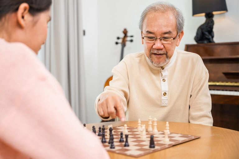 seniors-doing-activities-playing-chess-senior-care-home-inspired-assisted-living