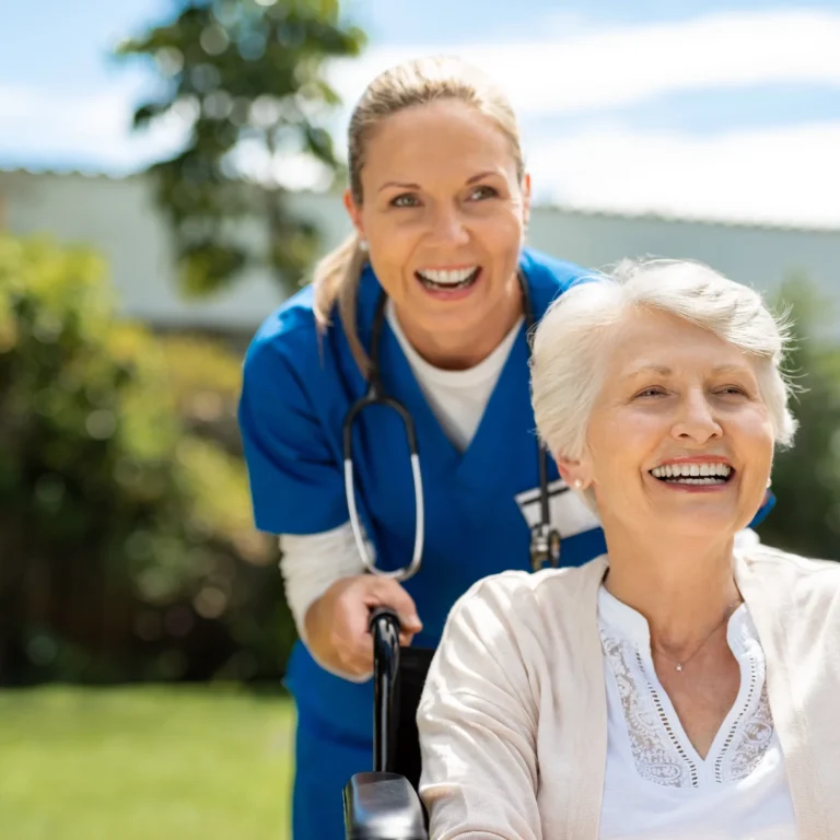 happy-nurse-and-elderly-woman-sitting-in-wheelchair