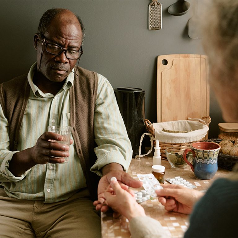 senior-black-man-receiving-medication-from-senior-2025-07-08-21-37-00-utc